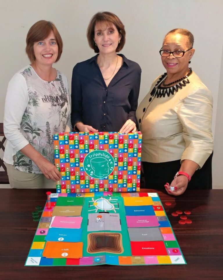 The Isivande Wellness team with Triippslide, the game. Anna Rodrigues (MA Play Therapy), Helen Frimas (MA Counselling Psychology) and Dr Simcha Mdaka (Ph.D Clinical Psychology).